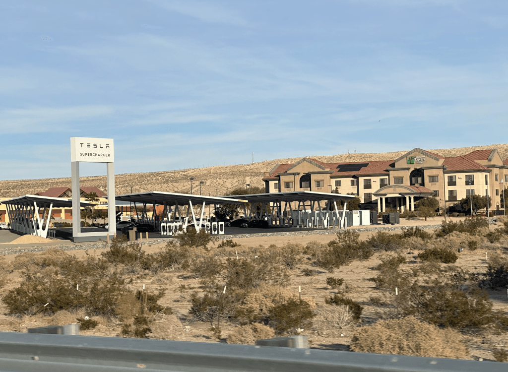 Photo of Tesla supercharger with many stalls. Indicating the Death of the Portable EVSE due to rise of so many chargers.